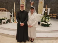Maren Latham with Fr. Philip Creurer, at her 2018 baptism.
